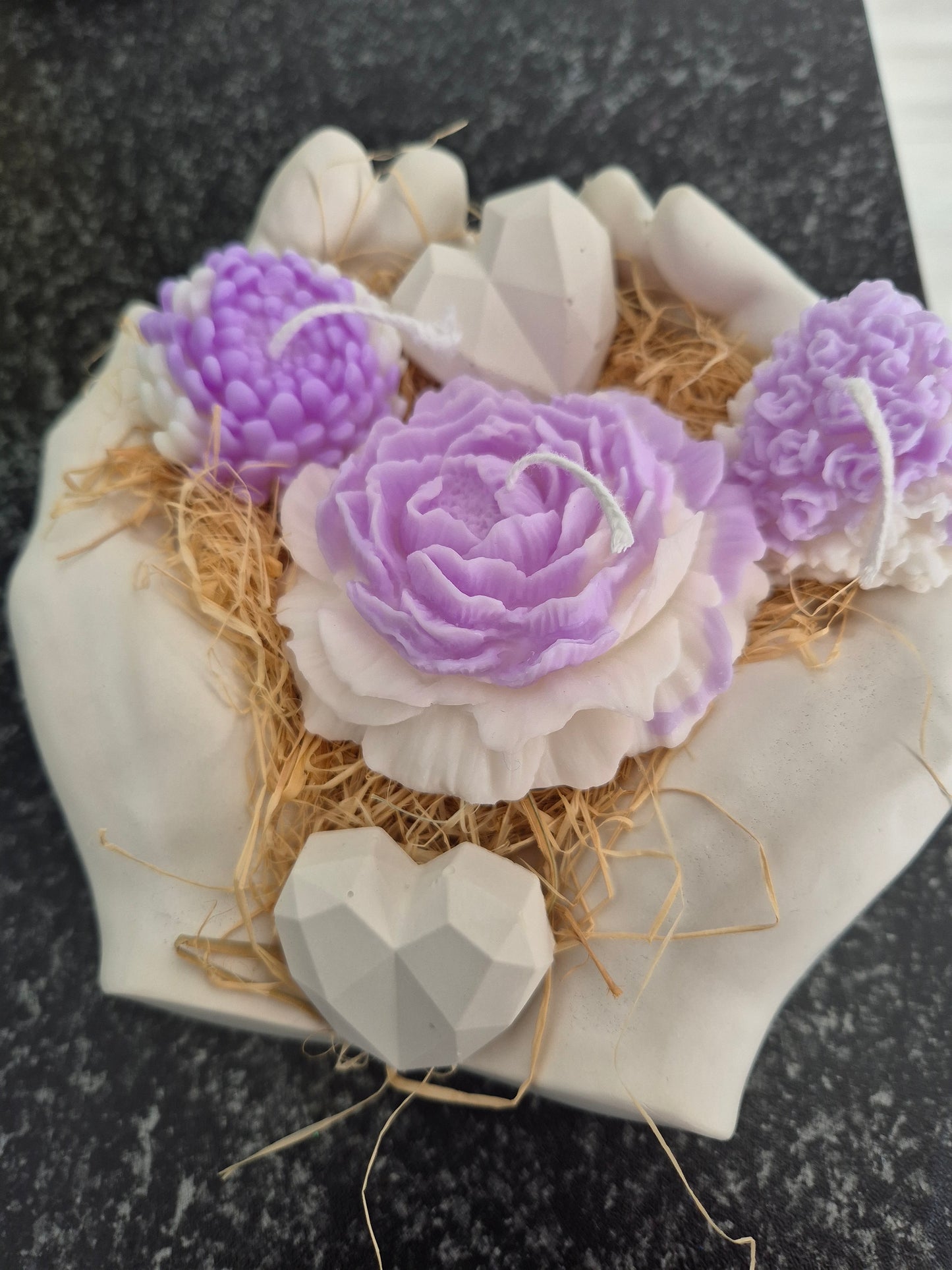 Beatifull hands made from gypsum with candles and gypsum hearts